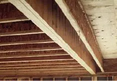 Because the individual LVLs in this built-up girder weren’t properly fastened together, the outermost lamination is carrying most of the loading, causing excessive deflection.