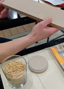 Acre board trim made from rice hulls. (A sample of the hulls is in the glass in foreground.)