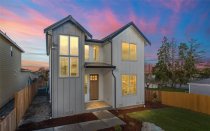 Move-up farmhouse plan for a narrow lot, front exterior. See details at Houseplans.