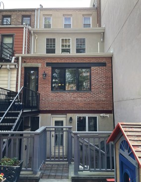 Before work began, the building stepped back on the second and third levels. Additions on the two levels will align with the brick wall of the main level.