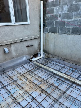 Along with the block work an extension of the basement-level slab is prepped for the pour.