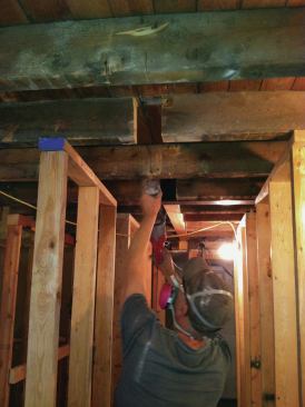 In order to flush-frame the three new 3 1/2-by-6-inch Microlams, we had to cut away the existing 3x6 joists and notch the ends of the Microlams so they would fit between the flanges of the W6x9. We started at one end of the room and worked toward the street side. We cut the joists, then fit the first Microlam into place, posting it up at one end. The widened beam pocket allowed us to sledgehammer the steel into place, nudging it toward the Microlam until the web of the steel I-beam flushed up with the Microlam's notched end.