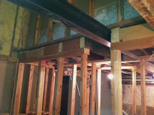 In an effort to create clear space in the apartment below, we removed the existing bearing wall at the stairwell.