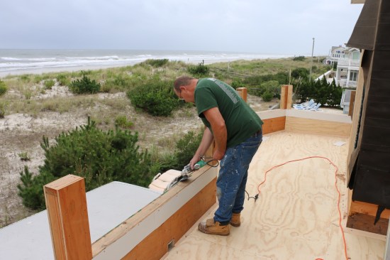 Using a disc grinder equipped with a sanding disc, fiberglass installer smooths out any rough edges that might keep the fiberglass from adhering.