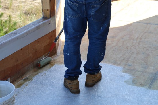 Next the installer soaks the field and the mat that extends up the vertical surfaces.