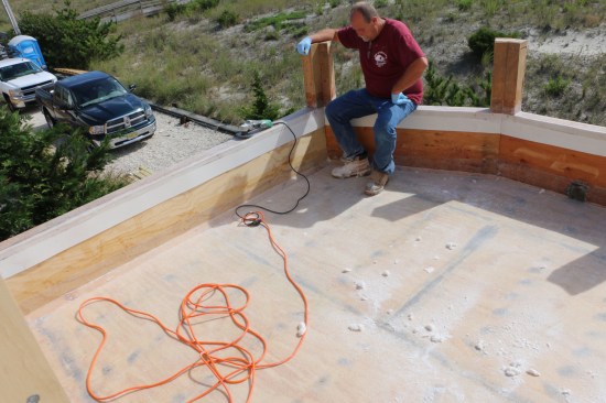 The next day, the installer goes over all the glassed surfaces with a sanding disc to rough them up before the finish coat.