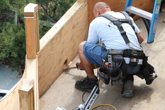 The deck used parapet walls as part of the railing. Scuppers made from square PVC sleeves are cut into the parapets for drainage.