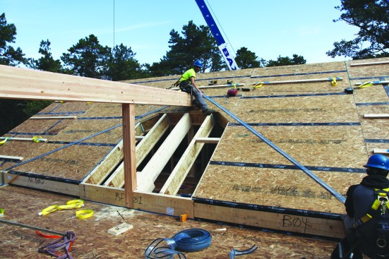 ... the crew staples gasketing to the roof in preparation for the next roof panels.