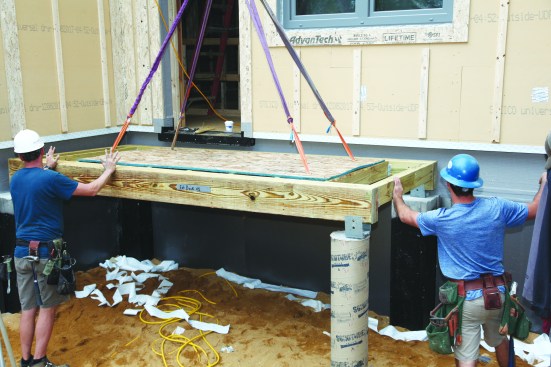 Even the porches are on this house are prefabricated in the factory. Supports for the inner porch walls are part of the foundation pour to avoid the need for a ledger.