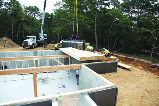 The crane sets the firstfloor deck panels.