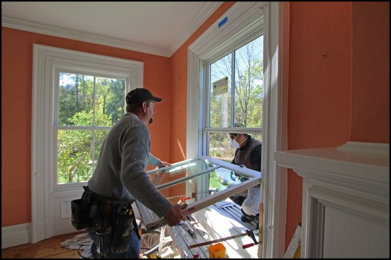 After fastening the window frame in the opening, the carpenters reinstalled the unit’s sashes. Some minor damage occurred as a result of pulling the windows (mainly where the trim fastened to the windows), so they were repaired and repainted.
