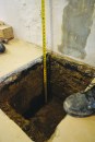The beam footing holes were 24 inches deep and extended 18 inches from the foundation wall.