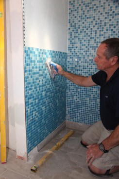 When all the tile for a section is finished, go over the entire surface, tapping with a rubber trowel.