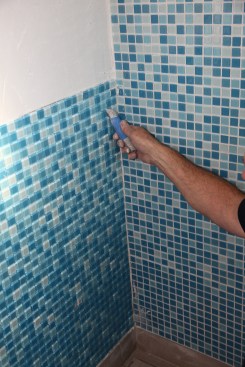 To avoid cutting tiny glass slivers to fill in along a corner, adjust the tile spacing instead.
