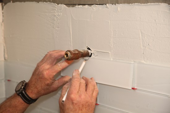 When the cut falls on a seam between tiles, set the tile roughly in position and mark out the cut.