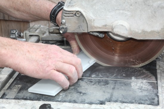 At the wet saw, make several cuts to the cut lines.