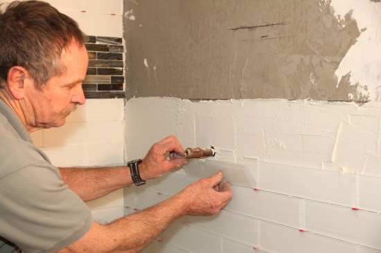 Then back-butter the tile and set it in place.