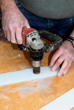 If the pipe falls in the middle of a tile, drill the hole with a hollow-core diamond-coated bit with a water feed.