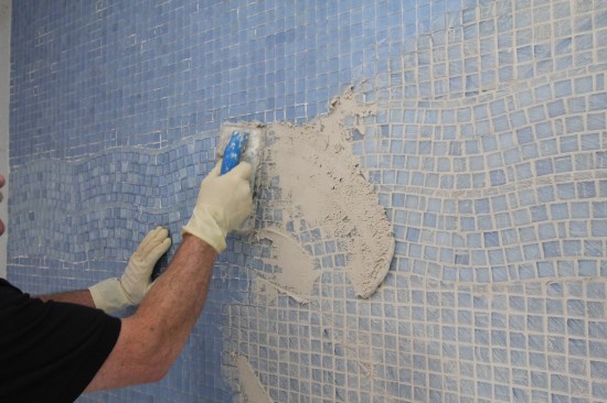 Because glass tile does not absorb moisture, use a grout mixture that is much stiffer, with less water than usual.