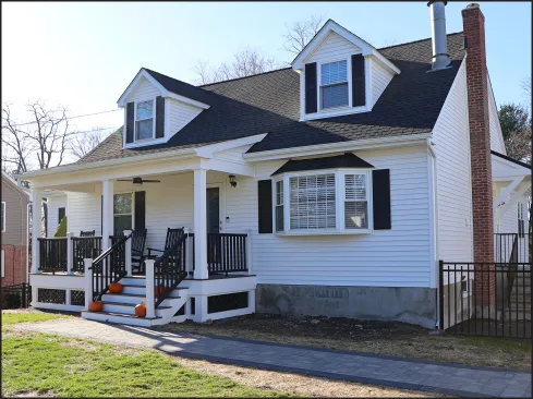 A new porch enhances the curb appeal of a homeowner’s mid-1950s Cape while offering the family a better transition to the outside.