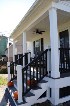 A Trex composite guardrail system encloses the completed porch.