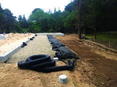 Then it wraps back over the crushed stone and drainage pipe.