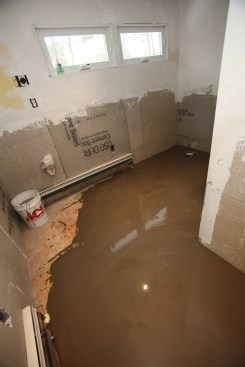 To leave the bathroom, the author had to take one step into the liquid, but it quickly filled back in around his footprint. The entire pour took only 15 minutes and the self-leveling liquid did the rest, providing a solid, flat, and level substrate for the tile floor. As a side note, the author covered the floor with an uncoupling membrane before installing the large-format floor tile. 