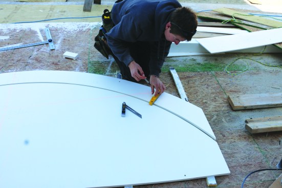 He then transfers the angle to the radiused stock and draws straight lines for the end cuts of the cap.