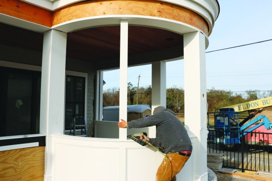 The crew wraps the intermediate posts in PVC using the same method described in “PVC Miter-Fold Post Wraps” (Jul/16). The PVC wraps nail directly to the 4x4 posts.