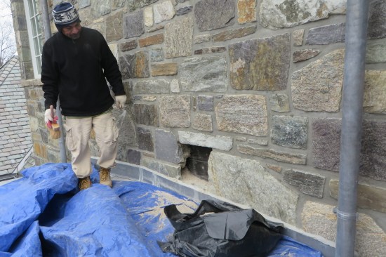 Removal of a stone confirmed that through-wall flashing had not been installed.