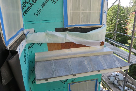 After the self-adhering membrane backup flashing was installed, the metal through-wall flashing was installed over it (seen here on an adjacent roof).