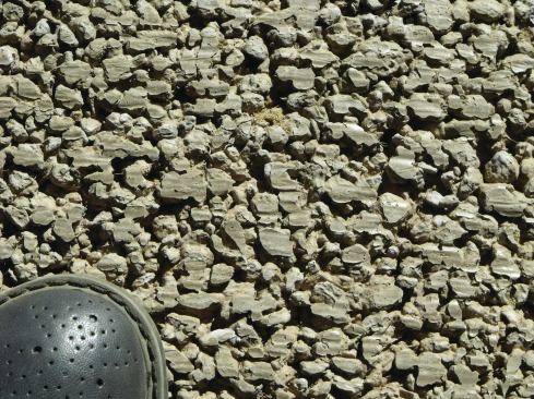 After seven days, we took off the plastic and stripped the forms, leaving a finished surface that was smooth overall and ready to be driven on, but that had voids between the aggregate. 