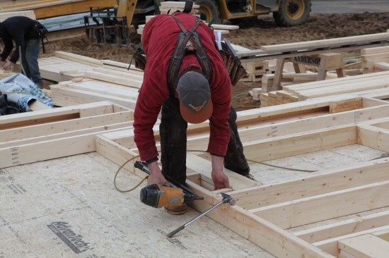 If needed, short cripples are cut to fill in the framing between the top plate and the header.