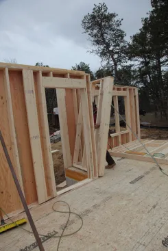 Small walls can be framed without sheathing, so they are much lighter. One person can build these walls in nearby free space on the deck and then slide the wall over to its position.