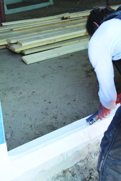 ... apply a heavy bead of caulk to the sill pan.