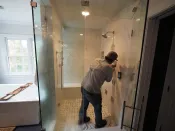 Enclosures for steam showers need to be fully water- and vapor-proofed on all sides. Surfaces, including ceilings, are typically tiled, and large areas of glass (door, side, and top wall panels) are used to let in outside light and increase ambiance.