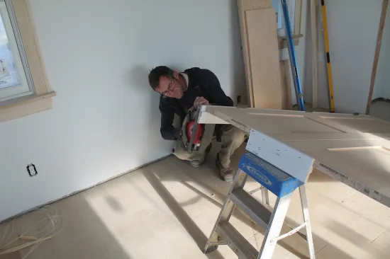 Keeping the double doors temporarily secured in the jamb, elevate the bottom to cut the jambs to length.