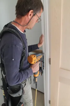 When completely satisfied with the fit, go back and drive nails at each shim point along the sides to secure the assembly in the opening.