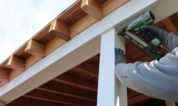 The wraps are made to go around the treated 4x4 posts and to fit inside the beam trim above. Nails hold the wrap in place while the fourth side is installed.