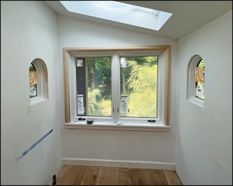The homeowners requested a plaster-look interior finish for a pair of small, arch-top windows in their bath remodel.