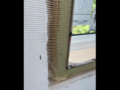 A temporary screed board made from ripped-down clear pine was run 1/4 inch proud of the jamb extensions. The screed’s edges were wrapped with plastic tape for easier release.