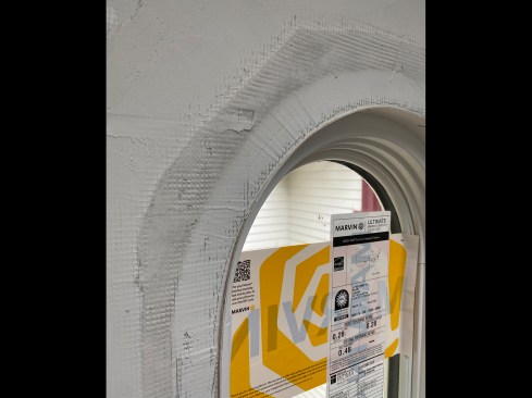 At the gap between the jamb and the drywall, the author pushed Durabond through the mesh about 1/2 inch to key it in. 