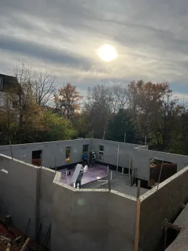 The block walk-out foundation was the first part of the new structure to be built on the sloped site.