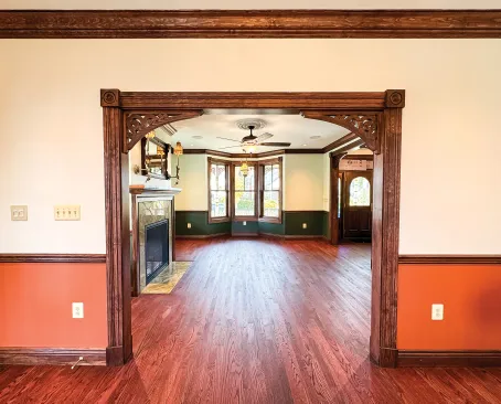 Hardwood floor and trim mirror the original home.