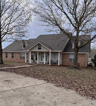 We tend to over-focus on rain coming from above, but runoff from rain falling on other areas of a site can often be even more devastating. Water running down this slope, for example, will be absorbed by the brick veneer, which will hold water in the wall and eventually cause microbial growth and decay of the structure behind the brick. 