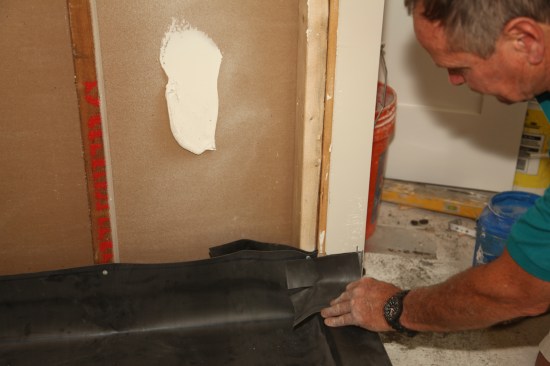 Cut an overlapping corner piece of membrane for each side of the threshold. 