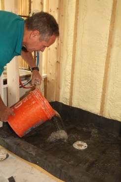 When the membrane is installed and all the joints are appropriately sealed, insert an expansion plug into the 
drain and dump about 10 gallons of water into the shower pan. Let the pan sit filled with water for three to four hours. Carefully inspect the drain and the floor below the shower for leaks before proceeding to the next step. 