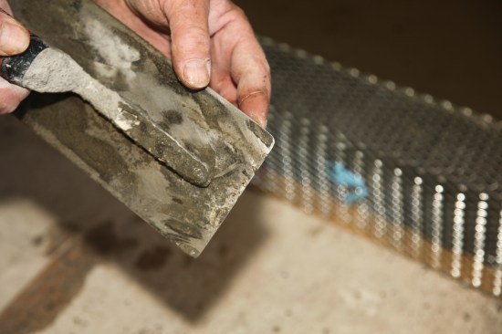 Be sure the corners of the steel trowel are rounded to keep them from damaging the membrane. 
