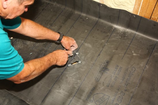 To connect the membrane to the drain, carefully cut the membrane from around the drain-assembly bolts, always cutting toward the middle of the drain.