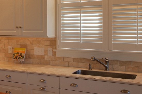 Switches near the sink control over-sink lights, while adjacent switches are for under-cabinet lights.